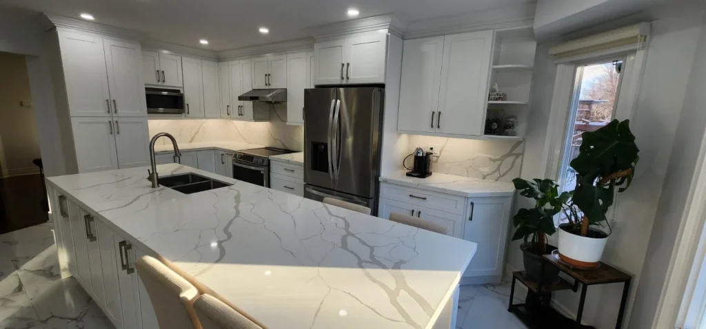 White shaker kitchen with large quartz island seating open shelving and stainless appliances by MD Kitchen and Bath
